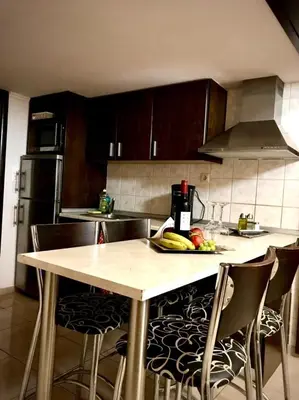 a kitchen with a table with fruit on it at Faliraki Seadream apartment,50m from the beach in Faliraki