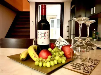 a bottle of wine and some fruit on a table at Faliraki Seadream apartment,50m from the beach in Faliraki