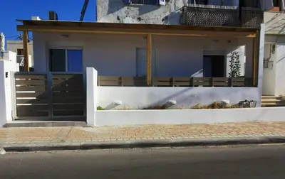 a white house with a gate and a fence at Blue View Zefiros in Rhodes Town