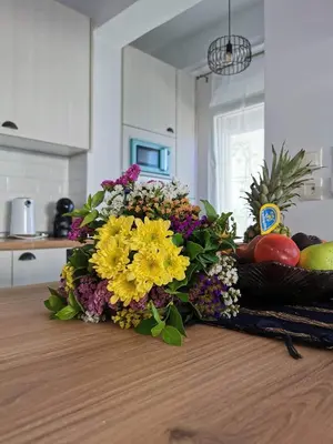 a bouquet of flowers on a counter in a kitchen at Blue View Zefiros in Rhodes Town