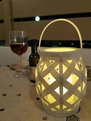a lantern sitting on a table with a glass of wine at Blue View Zefiros in Rhodes Town