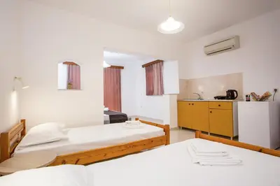 a room with two beds and a kitchen at Anastasia Apartment 9 in Afantou