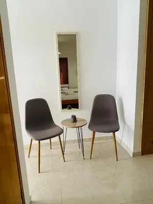two chairs and a table in front of a mirror at Anastasia Apartment 9 in Afantou
