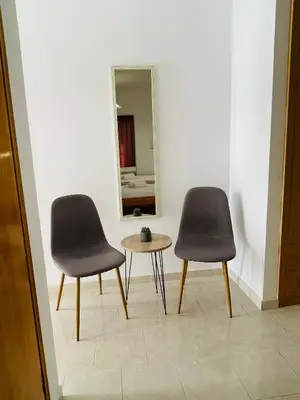 two chairs and a table in front of a mirror at Anastasia Apartment 9 in Afantou