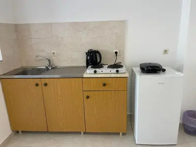 a kitchen with a sink and a stove and a refrigerator at Anastasia Apartment 9 in Afantou