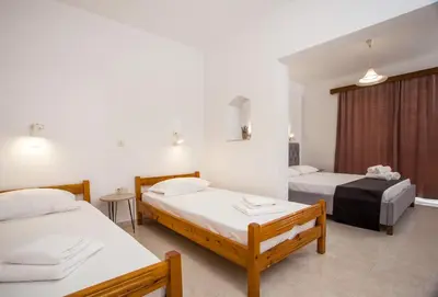 a hotel room with two beds and a window at Anastasia Apartment 9 in Afantou