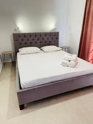 a bed with two towels on it in a room at Anastasia Apartment 9 in Afantou