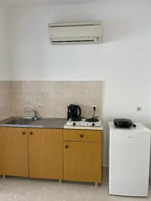 a kitchen with a sink and a stove and a refrigerator at Anastasia Apartment 9 in Afantou