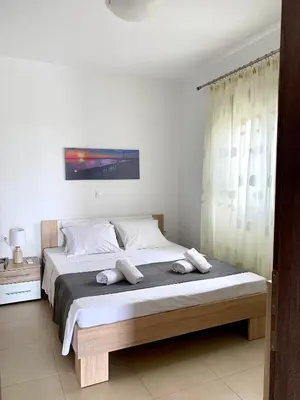 a bed with two pillows on it in a bedroom at Elena villa-apartments in Asklipiḯon