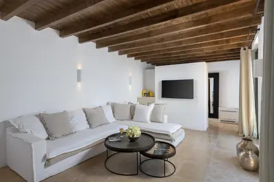 a white living room with a white couch and a table at Aquavisionaire Beach Front Villa in Líndos