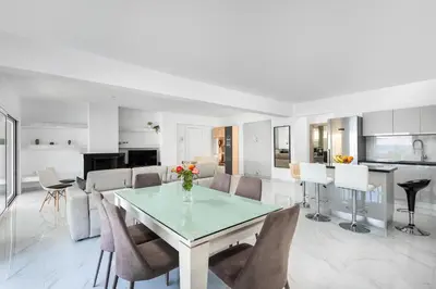a dining room and living room with a table and chairs at Viviane Paulos Villa in Gennadi