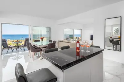 a living room with a table with wine glasses on it at Viviane Paulos Villa in Gennadi