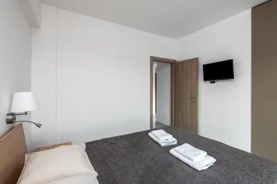 a bedroom with a bed with two towels on it at Viviane Paulos Villa in Gennadi