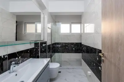 a bathroom with a tub and a toilet and a sink at Viviane Paulos Villa in Gennadi