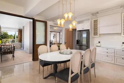 a kitchen and dining room with a table and chairs at Vento Imperiale Estate in Rhodes Town