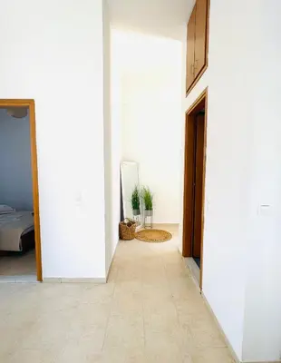 a hallway with a door leading into a room at Casa Chara in Symi