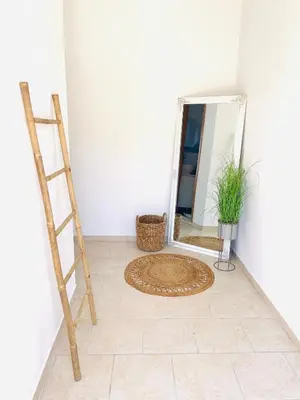 a room with a mirror on the floor and a ladder at Casa Chara in Symi