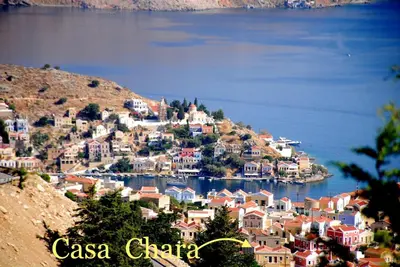 a view of a town on a hill next to the water at Casa Chara in Symi