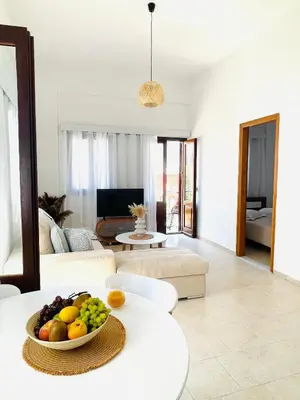 a living room with a bowl of fruit on a table at Casa Chara in Symi