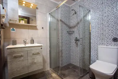 a bathroom with a shower and a toilet and a sink at Oleana City Center in Rhodes Town