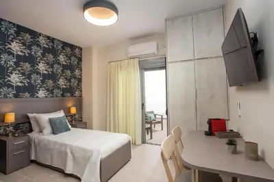 a bedroom with a bed and a table and a dining room at Oleana City Center in Rhodes Town