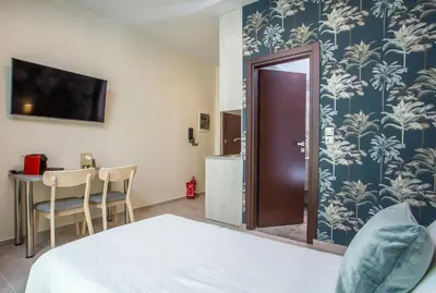 a bedroom with a bed and a table with a television at Oleana City Center in Rhodes Town