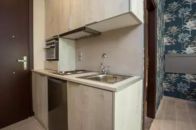 a small kitchen with a sink and a microwave at Oleana City Center in Rhodes Town