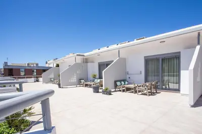 a patio with tables and chairs on a building at Oleana City Center in Rhodes Town