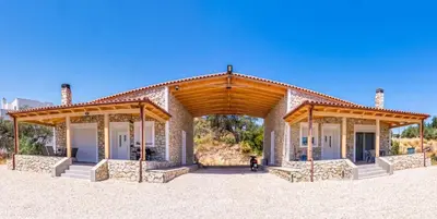 a building with awnings and a person standing in front of it at George's Paradise in Afantou