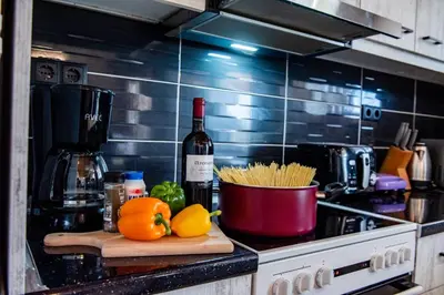 a kitchen counter with a bottle of wine and some oranges at George's Paradise in Afantou