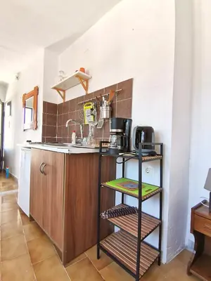 a kitchen with a sink and a counter at Small apartment (studio) in town with sea view in Rhodes Town