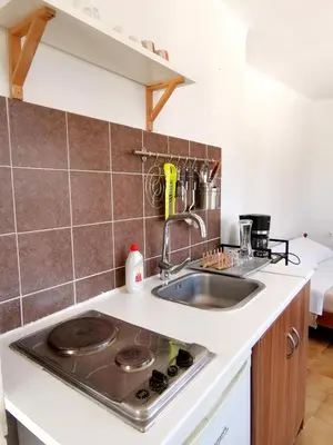 a kitchen with a sink and a stove at Small apartment (studio) in town with sea view in Rhodes Town