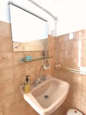 a bathroom with a sink and a mirror at Small apartment (studio) in town with sea view in Rhodes Town