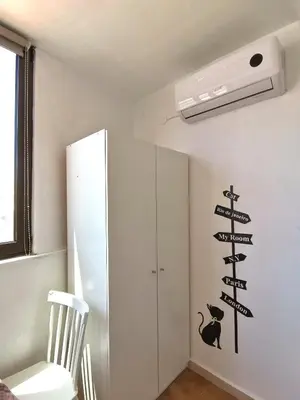 a room with a white wall with signs on the wall at Small apartment (studio) in town with sea view in Rhodes Town