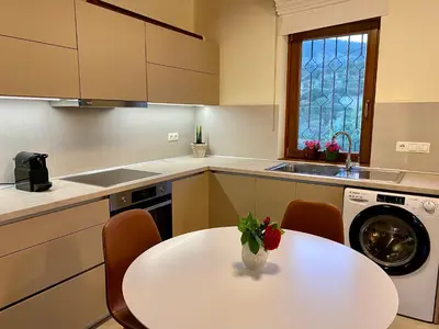 a kitchen with a white table and a sink at Greenview Maisonnette in Apóllona
