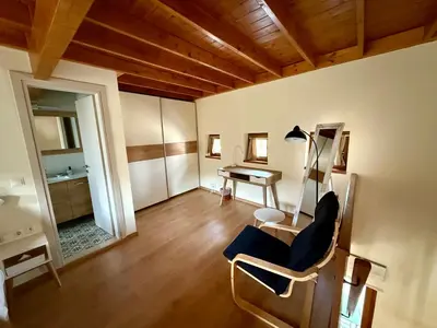 a living room with a chair and a desk at Greenview Maisonnette in Apóllona