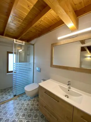 a bathroom with a sink and a toilet and a mirror at Greenview Maisonnette in Apóllona