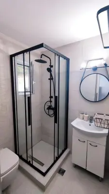 a bathroom with a shower and a toilet and a sink at Stegna Rita's apartment in Archangelos