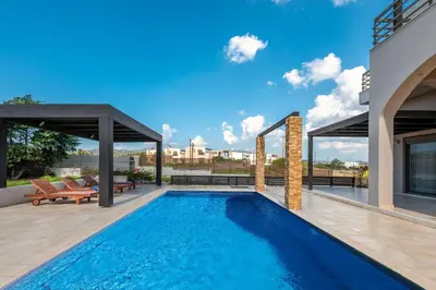 a swimming pool in the middle of a house at Blue Wave Villa - road view in Gennadi