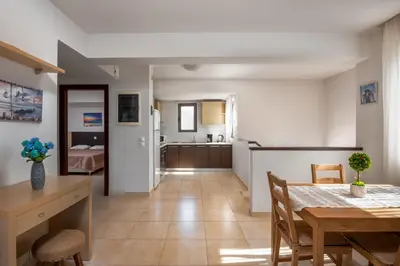a kitchen and dining room with a table and a dining room at Blue Wave Villa - road view in Gennadi