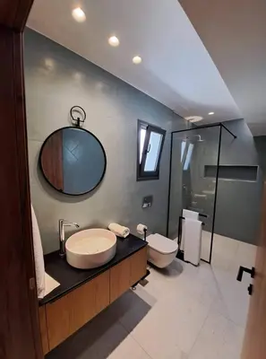 a bathroom with a sink and a toilet at Courtyard Luxury Suites “MARIANTHI” in Pefki Rhodes