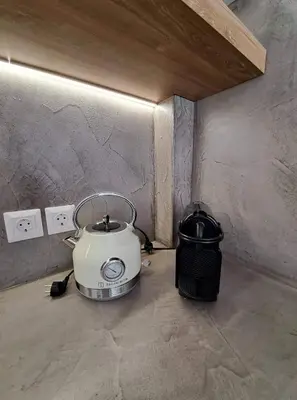 a toaster sitting on the floor next to a wall at Courtyard Luxury Suites “MARIANTHI” in Pefki Rhodes