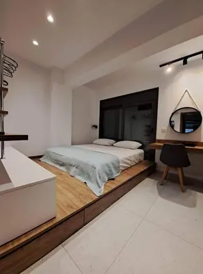 a bedroom with a large bed and a desk at Courtyard Luxury Suites “MARIANTHI” in Pefki Rhodes