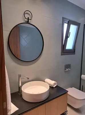 a bathroom with a sink and a mirror on a counter at Courtyard Luxury Suites “MARIANTHI” in Pefki Rhodes