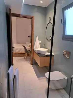 a bathroom with a sink and a toilet and a mirror at Courtyard Luxury Suites “MARIANTHI” in Pefki Rhodes