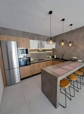 a large kitchen with a counter and a refrigerator at Courtyard Luxury Suites “MARIANTHI” in Pefki Rhodes