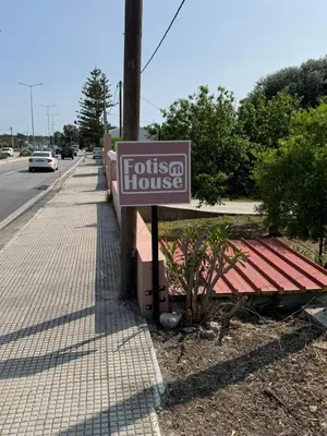 a sign for a fossta house on a street at Fotis house in Afantou
