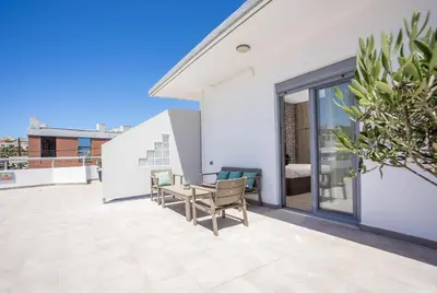 a patio with a table and chairs on a building at Oleana di Castello in Rhodes Town