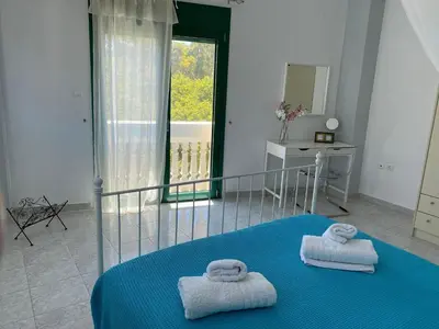a bedroom with two towels on a blue bed at Paraskevi's Apt - City Center w/ Lovely Park View in Rhodes Town