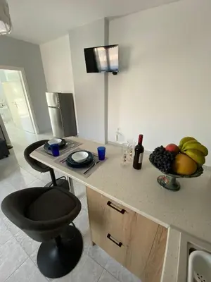 a kitchen with a counter with a bowl of fruit on it at Paraskevi's Apt - City Center w/ Lovely Park View in Rhodes Town